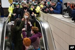 Climate activist Greta Thunberg, center, arrives at Central Railway station in Glasgow, Scotland, Oct. 30, 2021, ahead of the start of COP26.