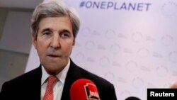 FILE - Former U.S. Secretary of State John Kerry talks to journalists during the One Planet Summit, near Paris, France, Dec. 12, 2017. 