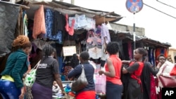 Women look at second hand clothes at roadside stall, in Nairobi, Kenya, April 8, 2018. 