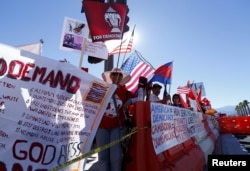 Protesters line one side of a roadway leading to Sunnylands where U.S. President Obama prepares to host leaders from Southeast Asia at the ASEAN Summit in Rancho Mirage, California, Feb. 15, 2016.