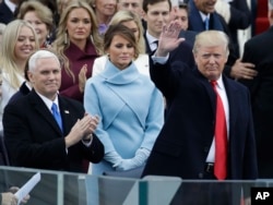 President-elect Donald Trump waves with Vice President-elect Mike Pence and his wife Melania Trump before the 58th Presidential Inauguration at the U.S. Capitol in Washington, Jan. 20, 2017.