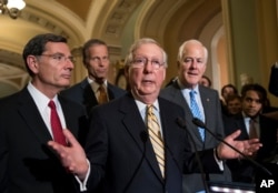 Senate Majority Leader Mitch McConnell of Kentucky, joined by, from left, Sen. John Barrasso, R-Wyo., Sen. John Thune, R-S.D., and Senate Majority Whip John Cornyn of Texas, speaks with reporters on Capitol Hill in Washington, July 25, 2017, after Vice President Mike Pence broke a 50-50 tie to start debating Republican legislation to tear down much of the Obama health care law.