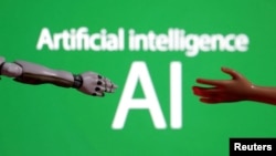 (FILE) Words reading "Artificial intelligence AI", miniature of robot and toy hand are pictured in this illustration taken December 14, 2023.