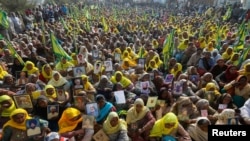 Women, including widows and relatives of farmers who were believed to have killed themselves over debt attend a protest against farm bills passed by India's parliament, at Tikri border near Delhi, India, December 16, 2020. 