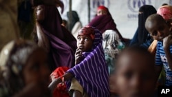 Somali refugees wait outside the UNHCR registration center in the Eastern Kenyan village of Hagadera near Dadaab, 100 kms (60 miles) from the Somali border, August 12, 2011