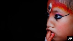 Nepal’s Kumari, or living goddess, watches the Rato Machindranath chariot festival in Lalitpur, Nepal, April 24, 2015.