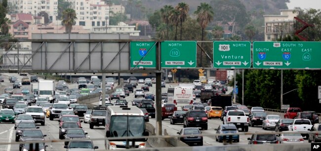 FILE - Vehicles are backed up while entering the US 101 Ventura Freeway as traffic from US 101 enters into downtown Los Angeles, Aug. 25, 2015.