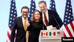 FILE - Mexican Economy Minister Ildefonso Guajardo, Canadian Foreign Minister Chrystia Freeland and U.S. Trade Representative Robert Lighthizer smile during a joint news conference on the closing of the seventh round of NAFTA talks in Mexico City, Mexico, March 5, 2018.