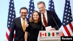 FILE - Mexican Economy Minister Ildefonso Guajardo, Canadian Foreign Minister Chrystia Freeland and U.S. Trade Representative Robert Lighthizer smile during a joint news conference on the closing of the seventh round of NAFTA talks in Mexico City, Mexico, in March.