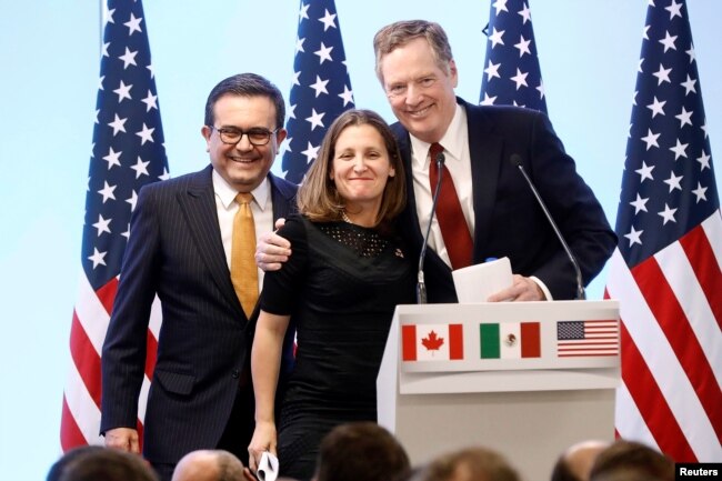 FILE - Mexican Economy Minister Ildefonso Guajardo, Canadian Foreign Minister Chrystia Freeland and U.S. Trade Representative Robert Lighthizer smile during a joint news conference on NAFTA talks in Mexico City, Mexico, March 5, 2018.