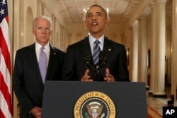 President Barack Obama, standing with Vice President Joe Biden, delivers remarks in the East Room of the White House in Washington, Tuesday, July 14, 2015, after an Iran deal is reached.