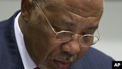 Former Liberian President Charles Taylor looks down as he waits for the start of a hearing to deliver verdict in the court room of the Special Court for Sierra Leone in Leidschendam, near The Hague, Netherlands, April 26, 2012. 