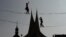 Tightrope artists balance on a rope in front of the Emmaus Monastery in Prague, Czech Republic.
