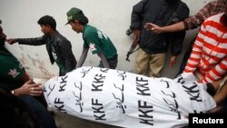 Men move the body of Syed Manzar Imam, a member of the Muttahida Qaumi Movement (MQM) political party and the Sindh provincial assembly who was killed by unidentified gunmen, from the morgue in Karachi's Abbasi Shaheed hospital, January 17, 2013. 