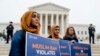 Zainab Chaudry, from left, Zainab Arain and Megan Fair with the Council on American-Islamic Relations, stand outside of the Supreme Court for an anti-Muslim ban rally as the court hears arguments about wether President Donald Trump's ban on travelers from several mostly Muslim countries violates immigration law or the Constitution, Wednesday, April 25, 2018.