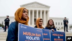 Zainab Chaudry, from left, Zainab Arain and Megan Fair with the Council on American-Islamic Relations, stand outside of the Supreme Court for an anti-Muslim ban rally as the court hears arguments about wether President Donald Trump's ban on travelers from several mostly Muslim countries violates immigration law or the Constitution, Wednesday, April 25, 2018.