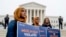 Zainab Chaudry, from left, Zainab Arain and Megan Fair with the Council on American-Islamic Relations, stand outside of the Supreme Court for an anti-Muslim ban rally as the court hears arguments about wether President Donald Trump's ban on travelers from several mostly Muslim countries violates immigration law or the Constitution, Wednesday, April 25, 2018.