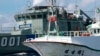 A Paluan law enforcement ship suspects a Taiwanese long line fishing vessel of illegal shark finning in Palau’s Exclusive Economic Zone, in violation of Palau’s law banning such fishing. (Alex Hofford/Greenpeace)