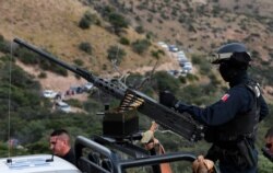 Escorted by heavily armed Mexican authorities, a caravan of friends and relatives of the LeBaron family arrive at the crime scene near Bavispe, at the Sonora-Chihuahua border, Mexico, Nov 6, 2019.