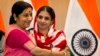 India's External Affairs Minister Sushma Swaraj, left, hugs Geeta, 23, a deaf and mute Indian woman who accidentally strayed into Pakistan as a child 12 years ago, during a press conference in New Delhi, India, Oct. 26, 2015. 