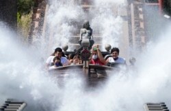 Visitors ride a roller coaster at Cinecitta World amusement park in the outskirts of Rome in the day of its reopening, June 17, 2021.