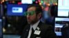 A trader wears a pair of "2017" glasses in anticipation of the New Year at the New York Stock Exchange in Manhattan, New York, Dec. 30, 2016.