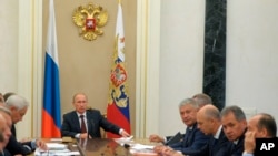 Russian President Vladimir Putin chairs a meeting on weapons modernization plans in the Kremlin in Moscow, Russia, Sept. 10, 2014.