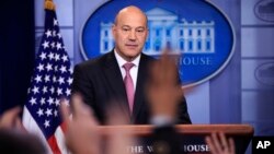 FILE - White House chief economic adviser Gary Cohn watches as reporters raise their hands to ask questions during the daily press briefing at the White House, Jan. 23, 2018.
