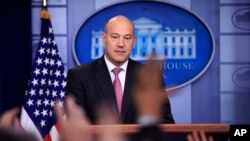 White House chief economic adviser Gary Cohn watches as reporters raise their hands to ask questions during the daily press briefing in the Brady press briefing room at the White House, in Washington, Jan. 23, 2018.