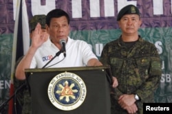 Philippines' President Rodrigo Duterte gestures as he talks to the troopers during his visit to Camp Teodulfo Bautista in Jolo, Sulu, Philippines, May 27, 2017.