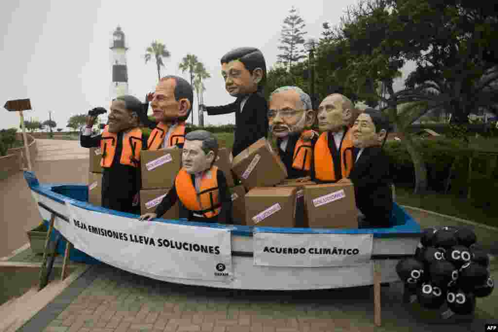 Activist depicting U.S. President Barack Obama, Australia's Prime Minister Tony Abbott, Canada's Prime Minister Stephen Harper, China's President Xi Jinping, India's Prime Minister Narendra Modi, Russia's President Vladimir Putin, and Japan's Prime Minister Shinzo Abe demonstrate on the sidelines of the U.N. COP20 and CMP10 climate change conferences being held in Lima, Peru.