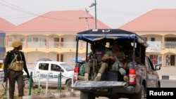 FILE - A police vehicle drives through Yola, in Adamawa state, Nigeria, Feb. 15, 2019. A Nigerian reporter has died after being found Jan. 15, 2020, bound and gagged in a farmer's field in the area.