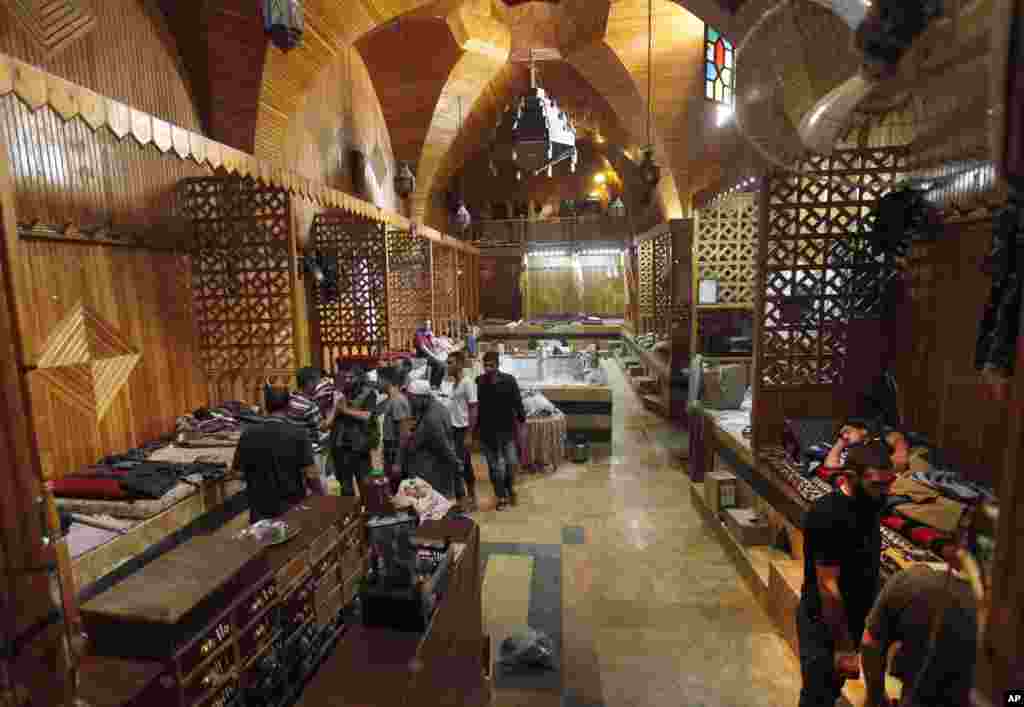 Free Syrian Army fighters gather at an old Turkish bath, or hamam, which served as a rebel base, in the souk of the old city of Aleppo, Syria, September 24, 2012.