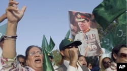 Supporters of political party Pakistan Muslim League hold a picture of army chief Gen. Ashfaq Parvez Kayani in Karachi, Pakistan. Pakistan's intelligence chief, Gen. Ahmed Shuja Pasha, admitted "negligence" on the part of authorities in failing to find bi