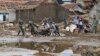 Rescuers pull a motorbike through the mud at a village badly hit by flash flood in Garut, West Java, Indonesia, Sept. 22, 2016. 