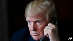 President Donald Trump talks with troops via teleconference from his Mar-a-Lago estate in Palm Beach, Fla., Nov. 22, 2018. 