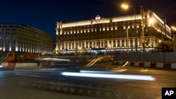 In this photo taken July 24, 2017, a car passes the building of the Federal Security Service in Lubyanskaya Square in Moscow, Russia. 