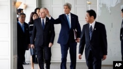 France's Foreign Minister Jean-Marc Ayrault, front left, U.S. Secretary of State John Kerry, center, Japan's Foreign Minister Fumio Kishida, front right, and their fellow G-7 foreign ministers are seen assembling for a working session in Hiroshima, wester