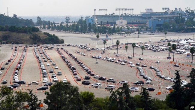 Motorists line up to receive a COVID-19 vaccine at a Los Angeles County location at Dodger Stadium in Los Angeles ,Wednesday, Feb. 10, 2021. (AP)