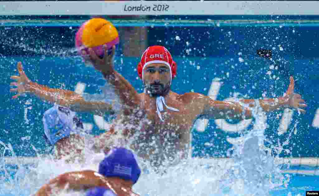 Greece's goalkeeper Filipos Karampetsos blocks the ball during the men's preliminary round Group A water polo match against Kazakhstan.