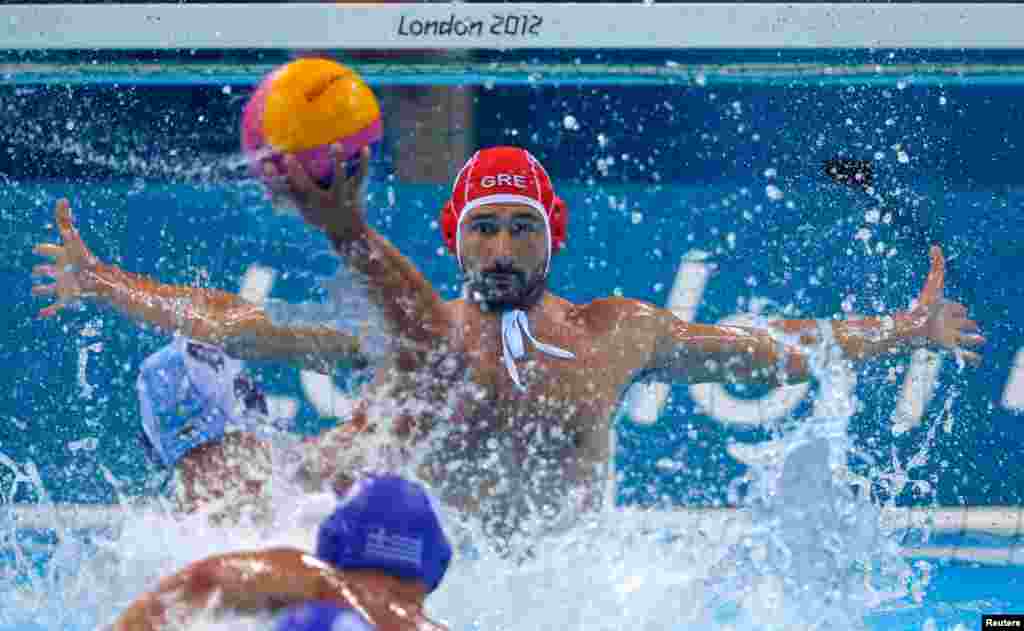 Greece's goalkeeper Filipos Karampetsos blocks the ball during the men's preliminary round Group A water polo match against Kazakhstan. 