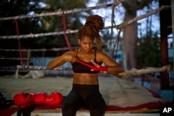 Boxer Idamelys Moreno wraps a bandage on her hand before a training session at a sports center in Havana, Cuba, Jan. 24, 2017.