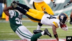 FILE - New York Jets free safety Jaiquawn Jarrett (37) tackles Pittsburgh Steelers' Antonio Brown (84) during the first half of an NFL football game in East Rutherford, New Jersey.