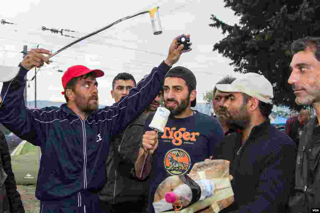 The Refugees.tv crew in action. Presenter and interviewer Mahmoud Abdulrahim has a background in acting (J. Owens/VOA).