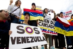 Anti-Venezuelan government protesters chant outside the Organization of American States’ headquarters in Washington during an emergency meeting on Venezuela, April 3, 2017.