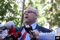 FILE - U.S. Charge d'Affaires Jeffrey Hovenier talks to members of the media after visiting U.S. pastor Andrew Brunson, who is being held under house arrest in Izmir, Turkey, Aug. 14, 2018.