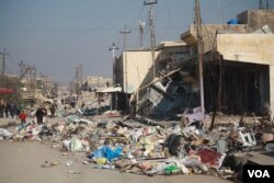 Marketplaces are often the center of neighborhoods, and when Iraqi forces take over, they base themselves in the center to secure the area, drawing IS suicide bombers and fire. At this market in the Sukkar neighborhood, the bodies of the bombers are rotting with the trash in Mosul, Iraq, Jan. 22, 2017. (H. Murdock/VOA)