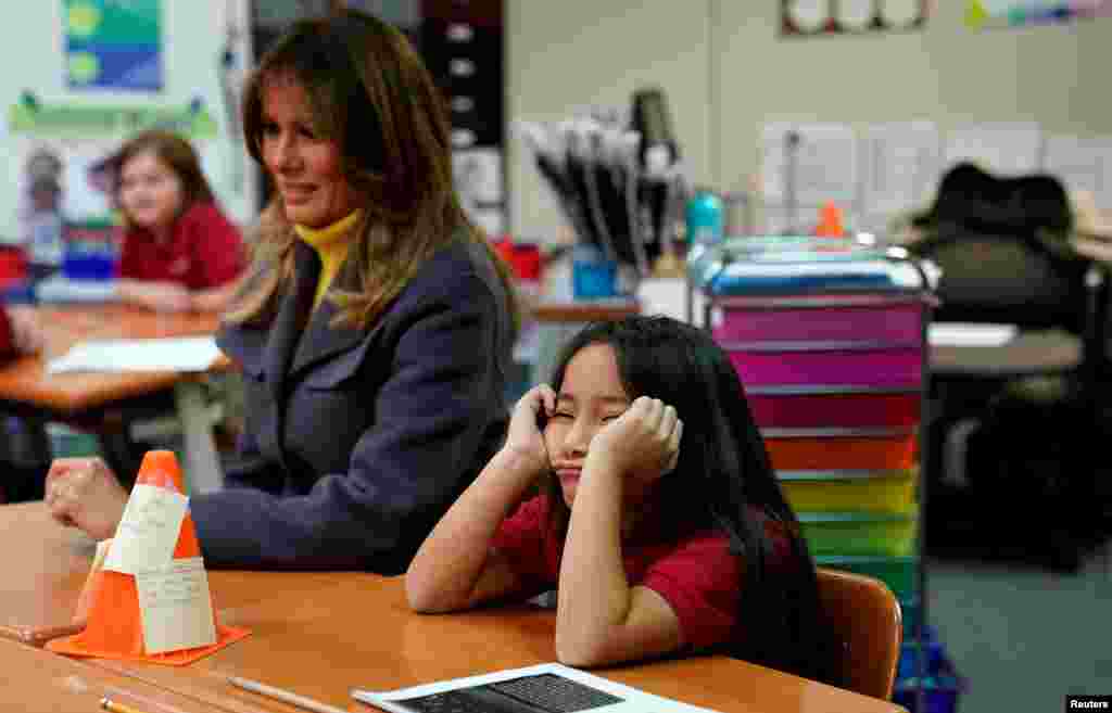 A student sits with her head in her hands as U.S. first lady Melania Trump visits the Dove School of Discovery during a two-day, three-state tour promoting her &quot;Be Best&quot; initiative in Tulsa, Oklahoma, March 4, 2019.