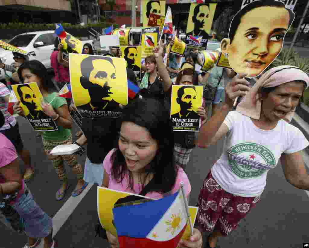 Protesters display placards showing national hero Apolinario Mabini, while shouting slogans outside the Chinese Consulate, Manila, June 12, 2014. 