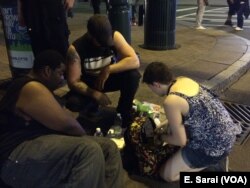 Joy, a Charlotte native with medical training, provides care to a protester who became severely dehydrated after marching for over three hours, in Charlotte, North Carolina, Sept. 24, 2016.